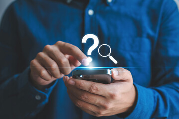 Searching for answers online concept man using smartphone with question mark and magnifying glass icon