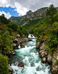 A rushing river winds through a verdant mountain valley, showcasing vibrant turquoise water and lush greenery.