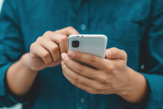 Man using smartphone mobile phone for social media texting and communication technology concept image