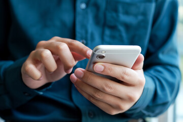 Man using mobile phone for communication and social media engagement with modern smartphone technology