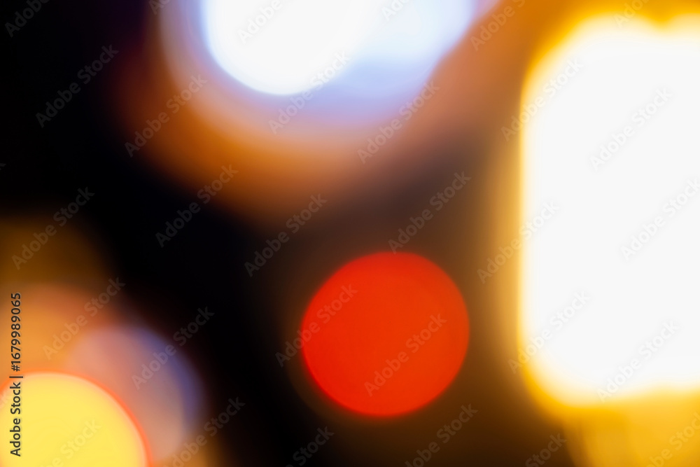 Poster abstract image showing blurred golden light with bokeh spheres against a dark background, creating a