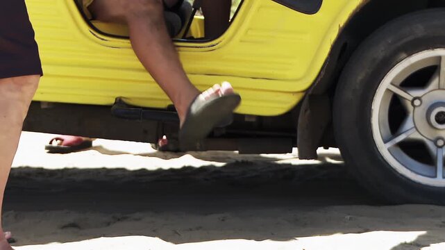 Nudist Men Arriving at Beach in Yellow Buggy and Removing Shorts, Low Angle View - 4K