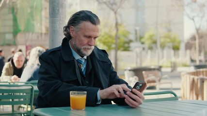 Businessman Using Phone at Outdoor Cafe - Powered by Adobe