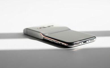 Futuristic Smartphone on White with Cinematic Shadow and Reflections