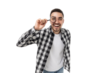 Young man playfully inspects with a magnifying glass, isolated, PNG