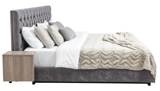 Luxurious bedroom setup featuring a button-tufted headboard, pillows, blanket, and a wooden bedside table