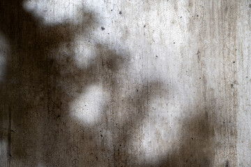 Abstract image of a grungy and aged cement surface. The texture features cracks and a shadow overlay. Copy space. Textured background