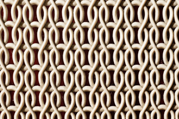 Closeup detail of a horizontal pattern comprised of parallel lines interspersed with repeating oval...
