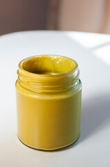 Sweet pistachio paste in a glass jar with copy space
