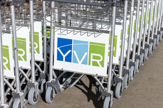Richmond, BC, CANADA - Oct 17 2024 : Close-up of stacked airport luggage carts with the YVR logo, in the site of Vancouver International Airport.