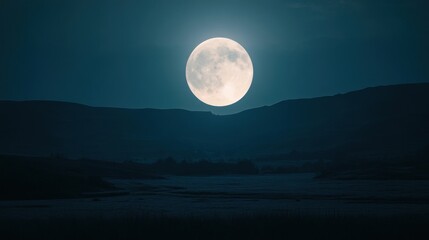 Full moon over a dark landscape