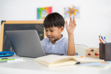Asian boy using laptop with course online learning, distance education for kids, e-learning at...