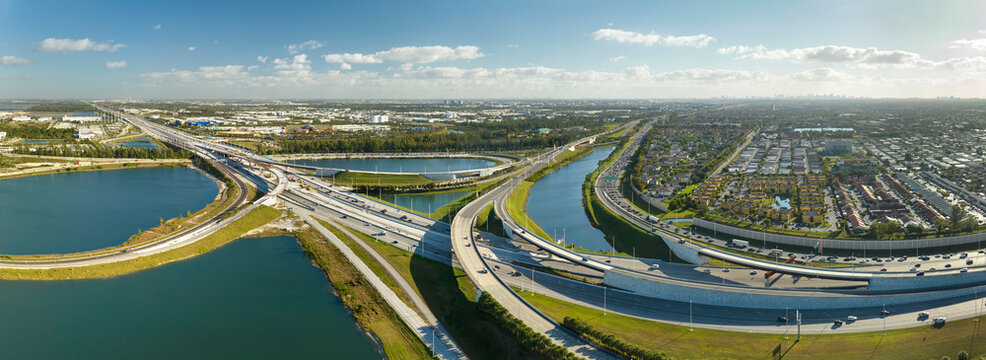 American big freeway intersection in Miami, Florida with fast moving cars and trucks. USA transportation infrastructure concept