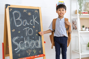 Asian schoolboy wearing uniform with backpack ready to learn at home, representing education, first day of school, childhood learning and academic preparation, education, back to school concept