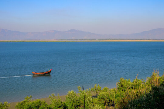 Lonely Wooden Boat Drifting on Naf River Surface, Bangladesh and Myanmar
