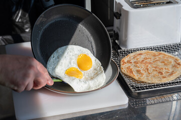 The chef fries the eggs sunny side up. 