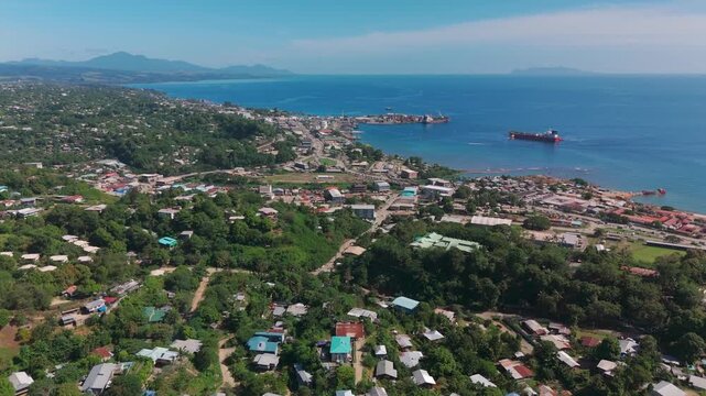 Birds eye moving view of Honiara harbour from the hilly suburbs.
