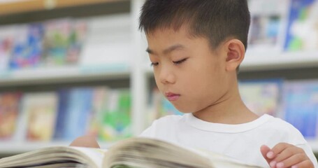 Children reading in the library - Powered by Adobe