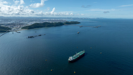 Aerial view crude oil tanker ship at sea, Green crude oil tanker ship top view, Logistic and maritime transpoprtation of petroleum, Modern offshore terminal  loading tanker ship.