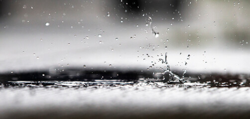 Raindrops on a dark blue background. Shallow depth of field.