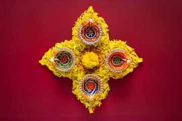Clay diya lamps lit to celebrate for Diwali festival with colorful decoration marigold flowers on...