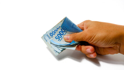 Hand Grasping Indonesian Rupiah Banknotes, IDR 50000 Cash Money Concept