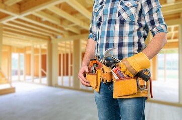 Carpenter constructing wooden frame house construction
