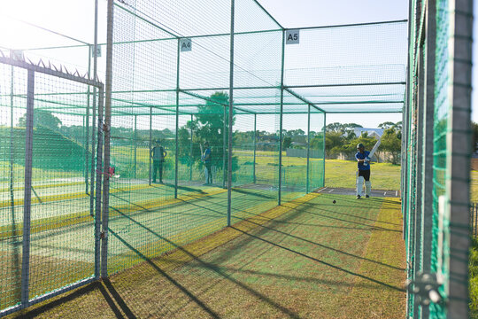 Indian male cricketers practicing batting at cricket nets a3, a4 and a5 with bat, ball, copy space