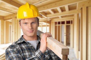 Carpenter constructing wooden frame house construction