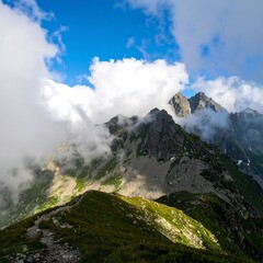 Majestic mountain peaks piercing through dramatic clouds on a sunny day.