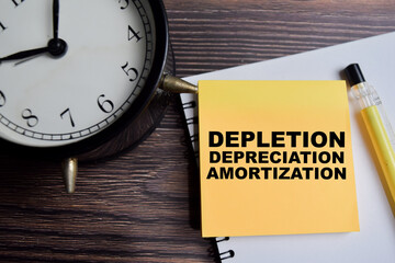 Concept of depletion depreciation amortization write on sticky notes isolated on Wooden Table.