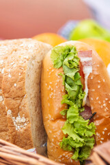 Vertical Horizon Picnic basket food bread fresh fruit coffee cup orange juice wood wicker box. Vertical Wheat bakery fruit food drinks green park outdoor lifestyle. Breakfast healthy appetizer box