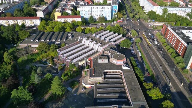 Sez and Volkspark Friedrichshain in Berlin, showcasing its lush greenery, a passing tram on a sunny day. Lovely aerial view flight panorama orbit drone