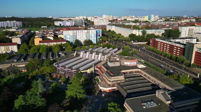 urban landscape of Berlin Friedrichshain, featuring the abandoned Sez a historical Gdr indoor swimming pool. Great aerial view flight descending drone