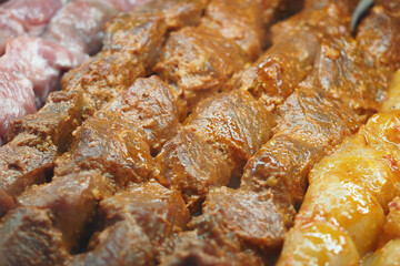 Grilled beef skewers at local market during evening hours