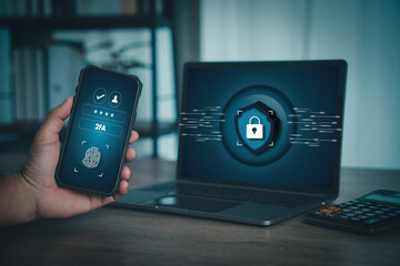 Two-factor authentication (2FA): user confirms identity with fingerprint and OTP on smartphone while signing into laptop. Secure login, cybersecurity, data protection and privacy in modern workspace.