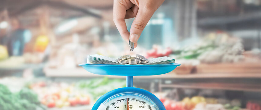 "Scale with coins, savings book and coin holder on market background. Finance and savings concept."