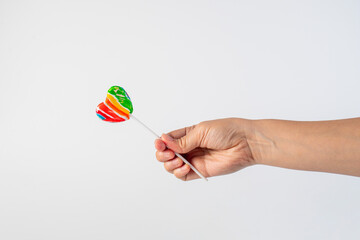 Sweets, lollipops in hand, on white background