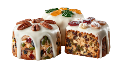 Traditional holiday fruitcakes decorated with nuts, candied fruits, and icing isolated on a white background