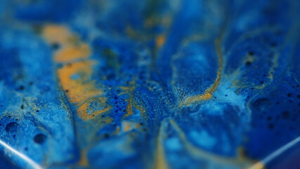 Ripple paint. Shiny fluid. Blur blue yellow color water texture dust ink bubble spreading on abstract creative acrylic background.