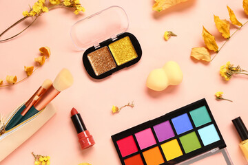 Composition with cosmetic products, yellow autumn leaves and flowers on light background