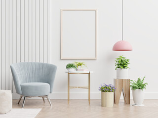 Chic living room interior with a comfortable pastel blue armchair, a vertical poster frame mockup, and decorative green houseplants