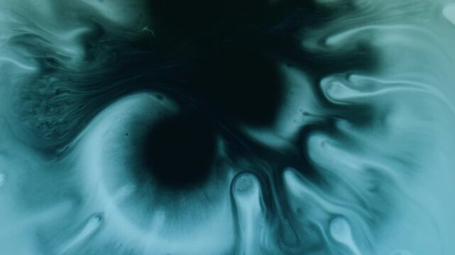 Dye blot. Wet blob. Black splotch drop paint on turquoise flow. Art color blending blue splatter stream abstract dissolve blur background.