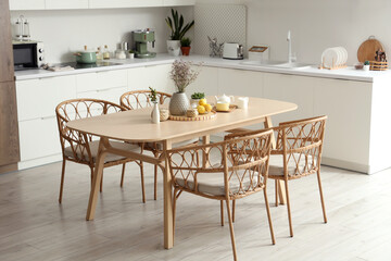 Wooden table with dried lavender, lemons and tea set in modern kitchen