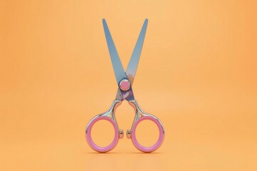Pink-handled scissors on orange background, studio shot, product photography