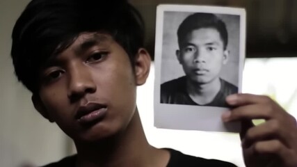 Young person holding vintage photo - Powered by Adobe