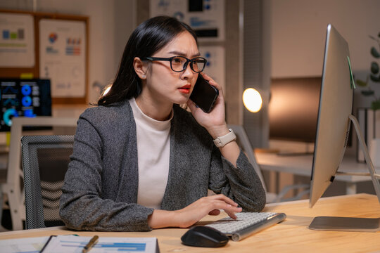 Stressed businesswoman working late and making a phone call - Powered by Adobe