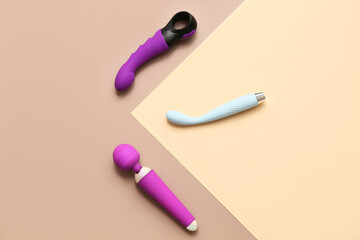 Set of vibrators on color background