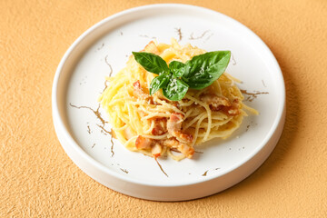 Plate with tasty pasta carbonara on beige background, closeup