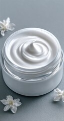Creamy white lotion in a jar, swirled, with white flowers